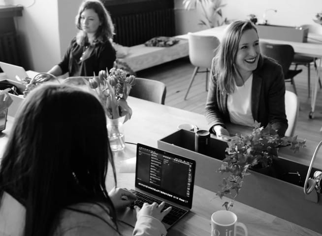 An image of 
        three adult women in an office.